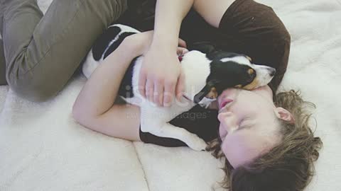 Young adult male cuddling and being affectionate with his pet dog stock