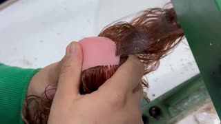 Doll Maker Sews On Hair