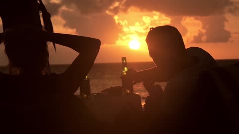 Drinking Beer On The Beach At Sunset