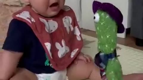 Cute babies play with dancing cactus