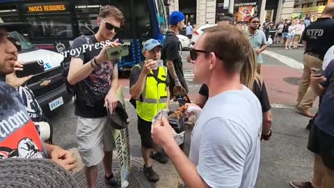 Man eats kabob in front of PETA protesters