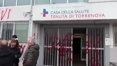 Italians deface central health building with blood red spray paint over the Covid-19 vaccines