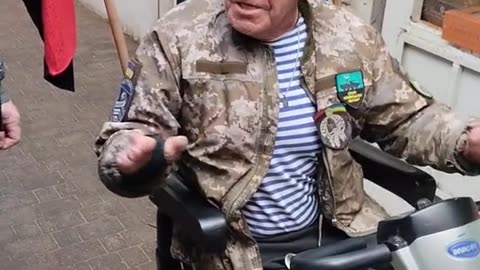 Ukraine in 30 seconds: a crippled man in a mobility scooter with a WWII Nazi collaborator