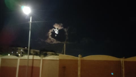 A cloud moving in front of the moon