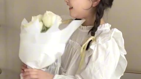 cute baby holding bouquet