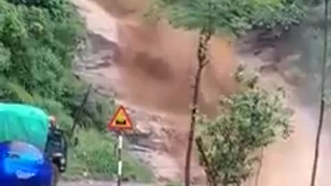 Chopper footage of damage from flash flooding and mudslides strand vehicles in Lao cai County