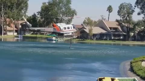 Canyon fire waterdropping helicopter refill.