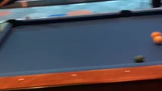 My daughter playing pool