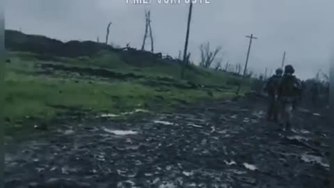 Russian mortar fire falling near Ukrainian soldiers on a Bakhmut road.