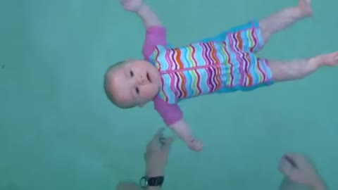 Cute baby swimming in water