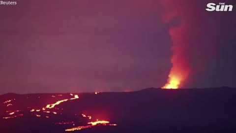 Fast-moving lava flows towards roads from Hawaii's Mauna Loa volcano