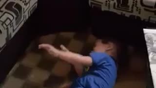 Boy plays with white dog