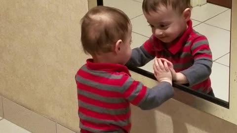 Boy Loves To Joke Around With His Reflection In The Mirror