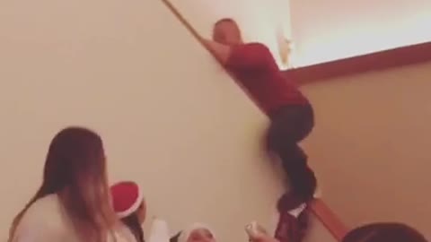 Man red shirt slides down stairs knocks down socks