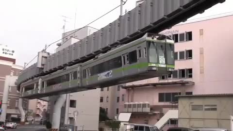 Air train system, a lightweight vehicle on rails, circling Japan over their heads.