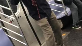 Man red flannel black jacket dancing on train