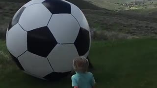 Dad kicks huge soccer ball and knocks baby out!