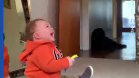 Baby laughs at mom exercising