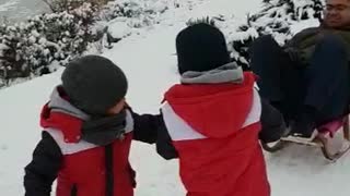 Kids pull dad in sleigh in Poland