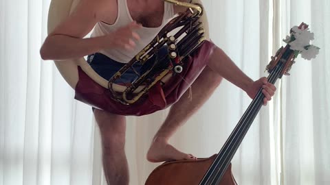 Circus Musician Plays Tuba and Bass at the Same Time