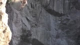 Guy backflips off of rocks belly flop loop