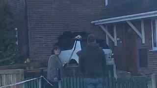 Car Stuck in the Side of a House