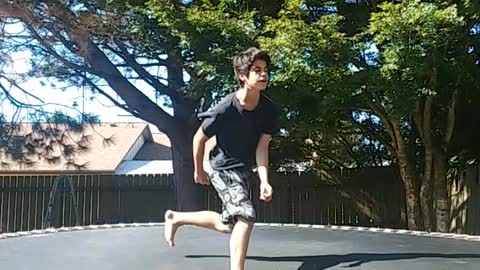 Kid does some flips on trampoline