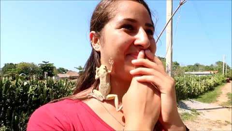 Witness the moment a frog jumps right on this girl's face!