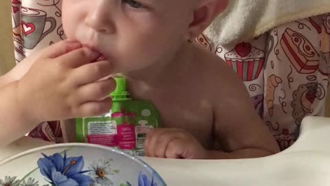 baby eats raspberries