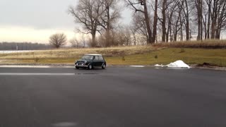 Serviceman Playing With Old Mini Cooper In Wet