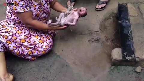 Incredible moment a woman rescues a baby which which dumped in a storm drain