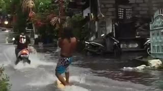 Surfer Enjoys the Rainy Season