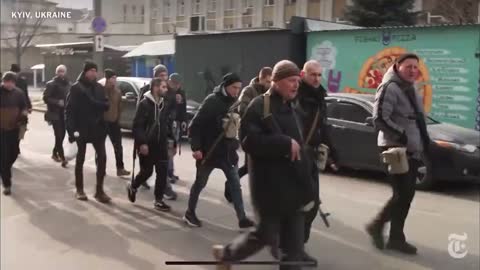 Citizens of Kyiv taking up arms as volunteers.