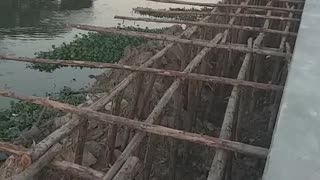 Hammer crane to drive long reinforced concrete pegs to make a canal wall