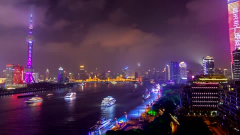 Multicolor city lights in Shanghai by the river