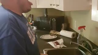 Guy in blue shirt in kitchen shotguns beer then loudly burps