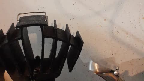 Fan and tea pot on wood stove.