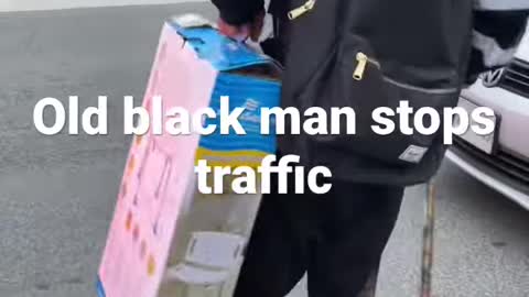 old black man stops traffic