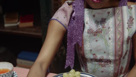 A Woman Eating Grapes With Her Cat On The Table--FH