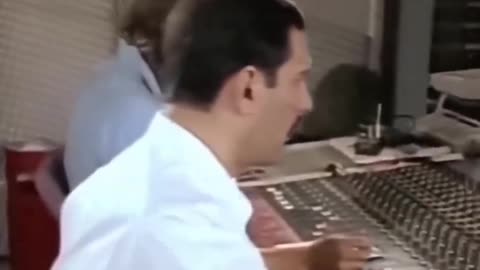 Freddy Mercury helping Brian May with his guitar part in the studio