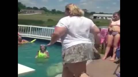 Woman preparing to jump into pool falls instead