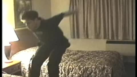 Young Man Does Backflips Between Hotel Beds, Fails