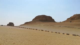 Italian Tourists Climbing El Modawara Mountain In Egypt