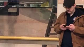 Man mustache hat standing in front of similar statue