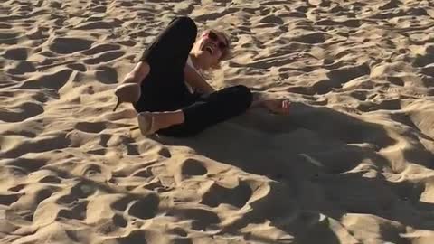 Girl on balance rope on the beach falls