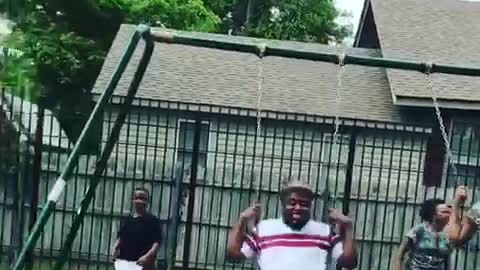 White pants fedora guy jumps out of swing set and falls into camera
