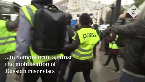 Russian police drag people into vans after they gathered to protest mobilisation of reservists