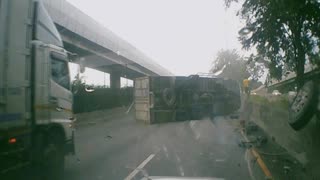 Truck Topples Over After Colliding With Barrier