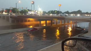 Car Takes on Flooded Underpass in Reverse