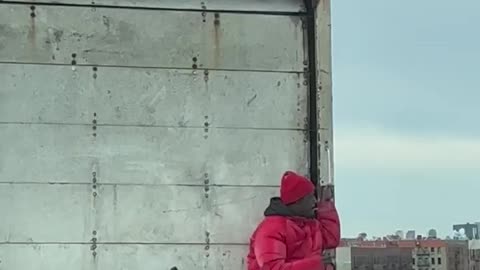 Man rides on back of truck to New York City